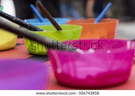 paints and brushes used to paint a picture