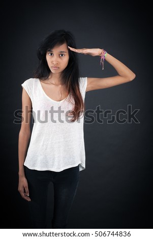 Beautiful woman doing different expressions in different sets of clothes: at attention