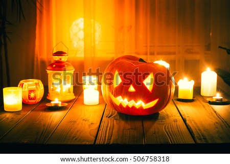 Amazing Pumpkin for Halloween with Candles on Wooden Background using for Wallpaper with Free Space for Text