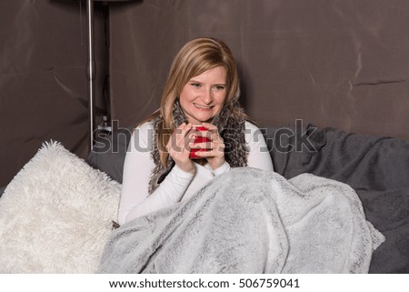 Attractive woman has a warming drink in her hand
