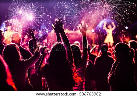 New Year concept - cheering crowd and fireworks Royalty-Free Stock Photo #506763982