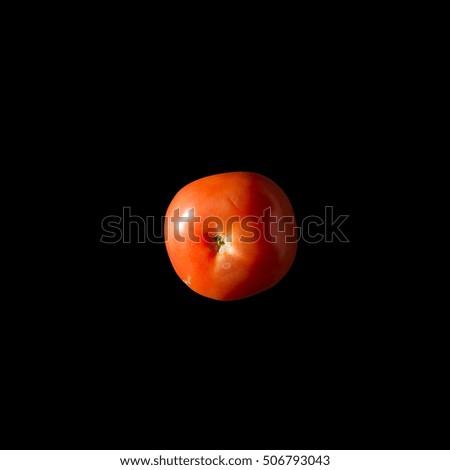 Red tomato on a black background