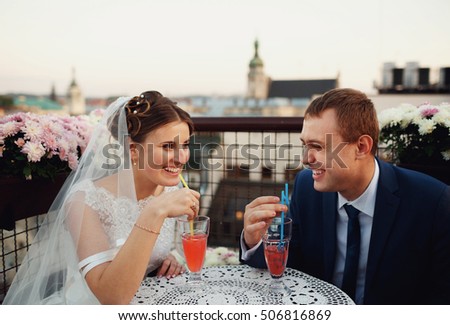 young lovers drinking cocktails outdoors