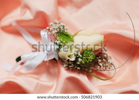 bouquet of colored roses on pink satin