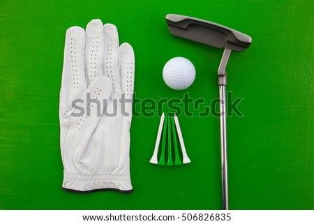 Different golf equipments on the green  desk - flat lay photography