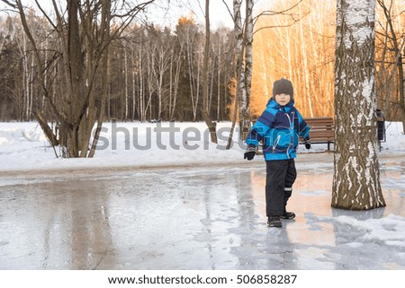 child boy on winter walk on ice