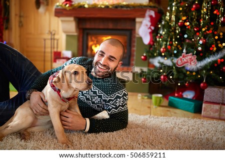 Smiling man with his dog on Christmas eve