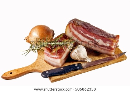 Bacon with black and white bow and a knife for cutting on wooden board.                              