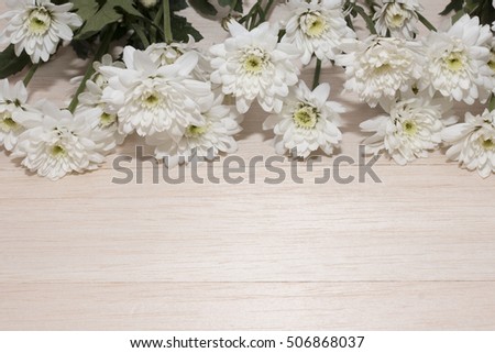 group of white flower on wooden desk,white flower have green leaf,green leaf make oxygen,copy space