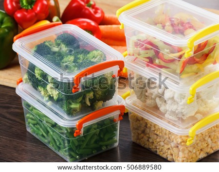 Trays with raw vegetables for freezing. Stocking up for winter storage in plastic containers Royalty-Free Stock Photo #506889580