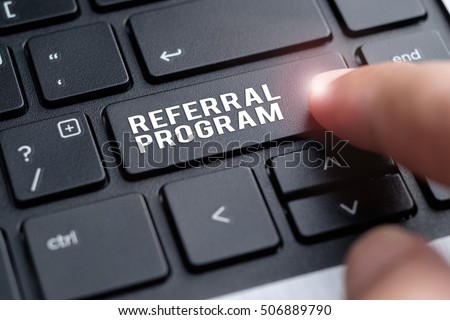 Finger on laptop keyboard written Referral Program Royalty-Free Stock Photo #506889790