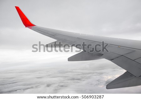 Sky cloudy with Wing of an airplane flying above the ocean. The view from an airplane window. Photo applied to tourism operators. picture for add text message or frame website. Traveling concept