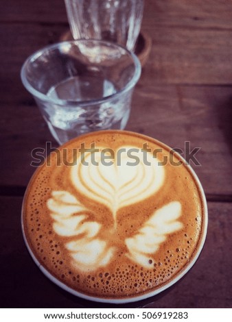 latte or cappucino coffee in dark tone retro filter effect