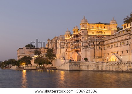 This photo was shot from Udaipur city at twilight time. Udaipur city palace was built over a period of nearly 400 years being contributed by several kings of the dynasty. Focus at the palace. Royalty-Free Stock Photo #506923336