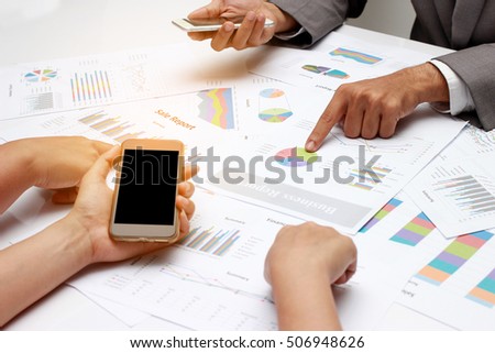 human hands of Group coworkers having discussion during meeting, business people discussing the charts and graphs showing the results of their successful teamwork.