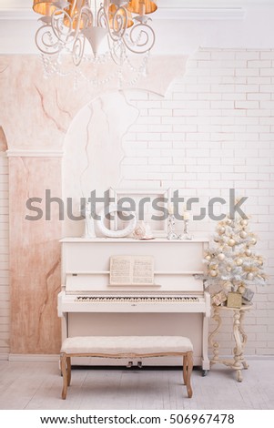 Classical white hall in winter time. Christmas tree with gift boxes under it. Xmas decoration in retro style