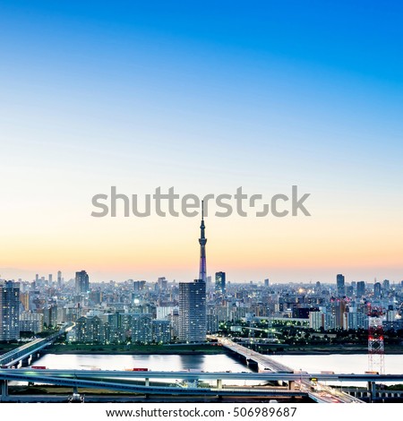 Business concept for real estate corporate construction - panoramic modern city skyline bird eye aerial night view with tokyo skytree under dramatic glow and beautiful dark blue sky in Tokyo, Japan