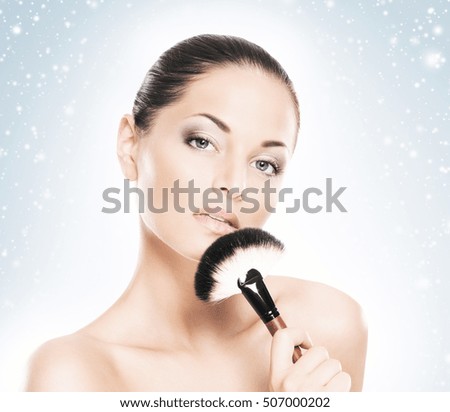 Face of attractive and healthy woman over winter Christmas background. Healthcare, spa, makeup and face lifting concept.