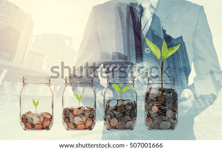 Double exposure of success businessman using digital tablet with coins in clear bottle,Business investment growth concept. (Elements of this image furnished by NASA)