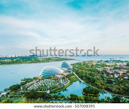 Business concept - panoramic modern city skyline bird eye aerial view of Gardens by the bay under dramatic morning blue cloudy sky in Singapore