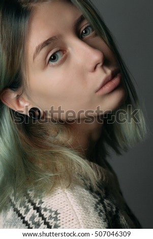 Gentle young woman. Studio portrait. Close up