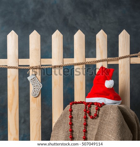 Santa hats hanging on a wooden fence. Decorations for the New Year.
