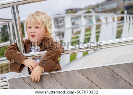 young happy child dressed like a pirate sailing an old wooden ship