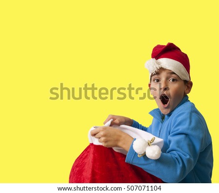 child on color background with christmas hat