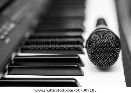 Close up microphone on piano keyboard in music studio. Music concept.