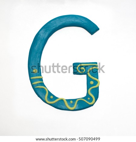 
Colorful font fashioned from clay. Letter "G". Isolated letter on a white background.