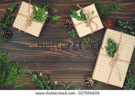 Christmas background with hand crafted gifts, presents  on rustic wooden table. Christmas or New year DIY packing. Holiday decor concept. Overhead, flat lay, top view, copy space