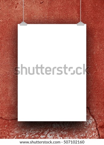 Single blank frame hanged by clips against red cracked concrete wall background