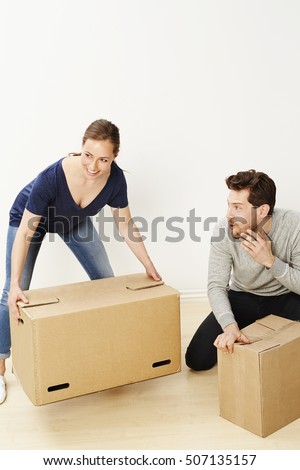 Sleazy dude looking at woman lifting boxes