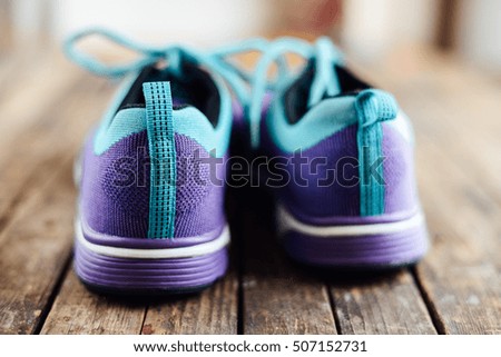  set for sports on wooden table, closeup. Rope and sneakers on the dark wooden background.  Shoe on wooden background. Sport clothes and accessories on a wooden background, View from above 