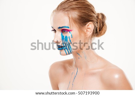 Beautiful woman with blue tears. Color make up. colorfully. stands sideways