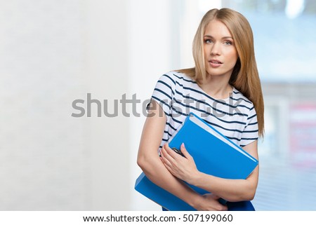 Portrait of smiling business woman with paper folder
