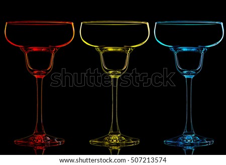 Silhouette of color margarita glass on black background.