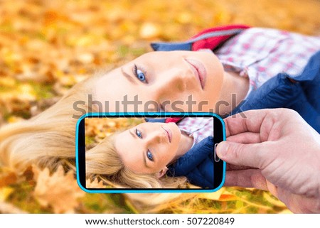 Making photos by smartphone of beautiful girl in autumn