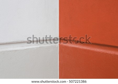 orange and white painted on cement wall