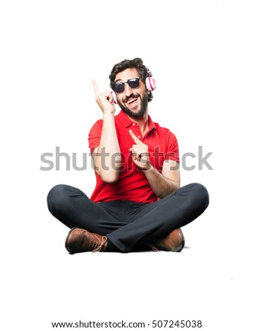 young funny man with headphones, sitting down.