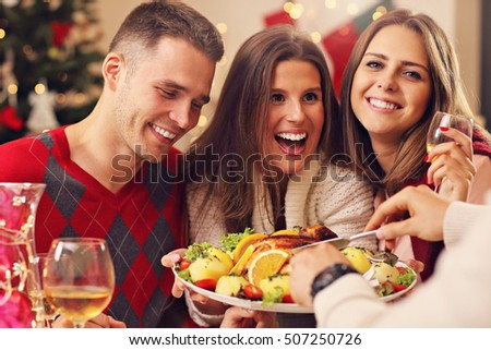 Picture showing group of friends celebrating Christmas at home