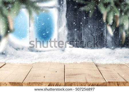 winter background of free space on wooden desk and snow decoration with landscape 