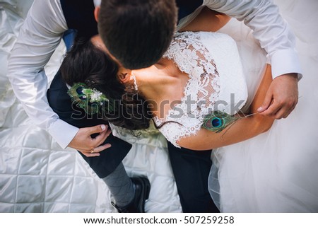 Bride lying on fiance's knees top view. Romantic moment man and woman sunny day.