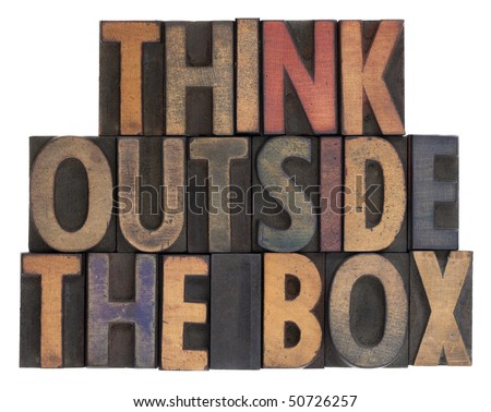 think outside the box phrase in vintage wooden letterpress type, stained by ink, isolated on white