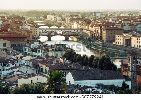 View of the city Florence with amazing bridge Ponte Vecchio,Tuscany, Italy. Sunset photo. Retro photo filter. Travel destination. Beautiful place.