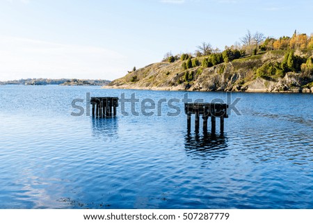 Mooring place with granite cliff in coastal landscape. Jarnavik in southern Sweden. Royalty-Free Stock Photo #507287779