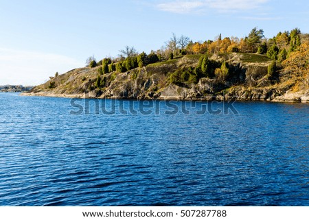 Granite cliff in coastal landscape in fall. Jarnavik in southern Sweden. Royalty-Free Stock Photo #507287788