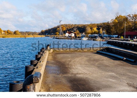 Jarnavik bay in southern Sweden in fall seen from an empty pier. Royalty-Free Stock Photo #507287806