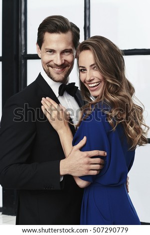 Happy and glamorously dressed couple, portrait
