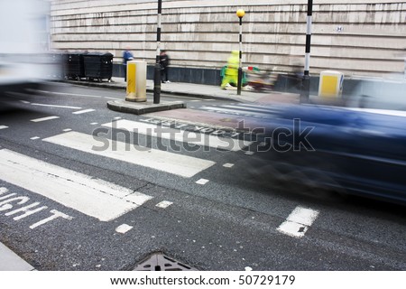 zebra crossing or pedestrian crossing in london with motion blur of traffic